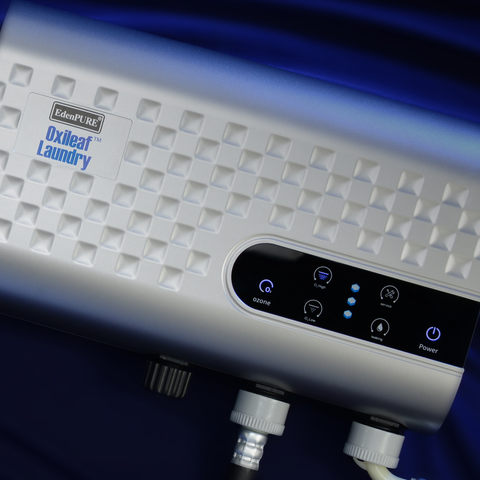 EdenPURE Oxileaf Laundry wash system with digital control panel and textured white body isolated on dark blue background